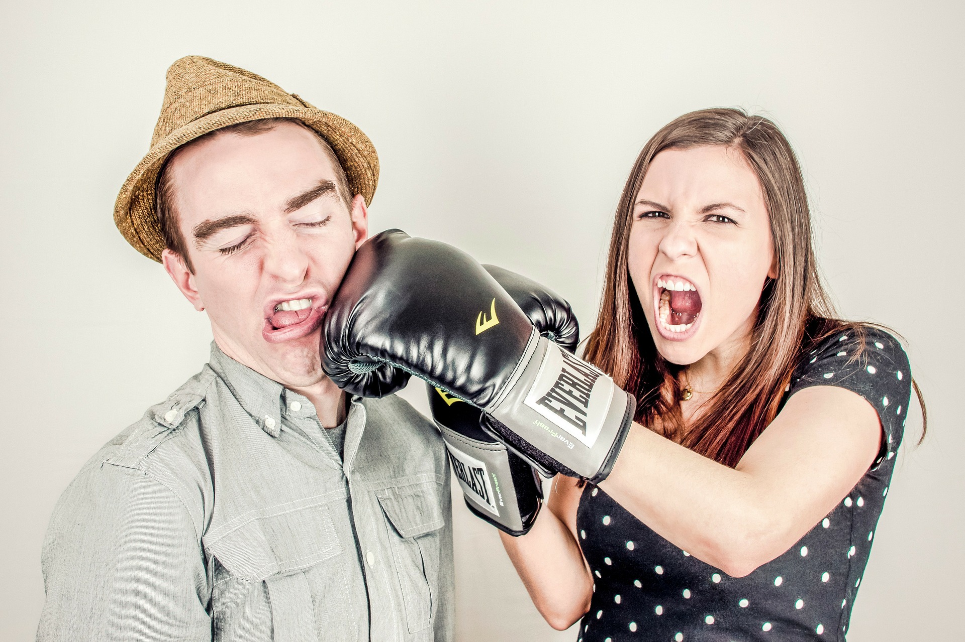 Woman with boxing glove punching man in face Commercial Litigation