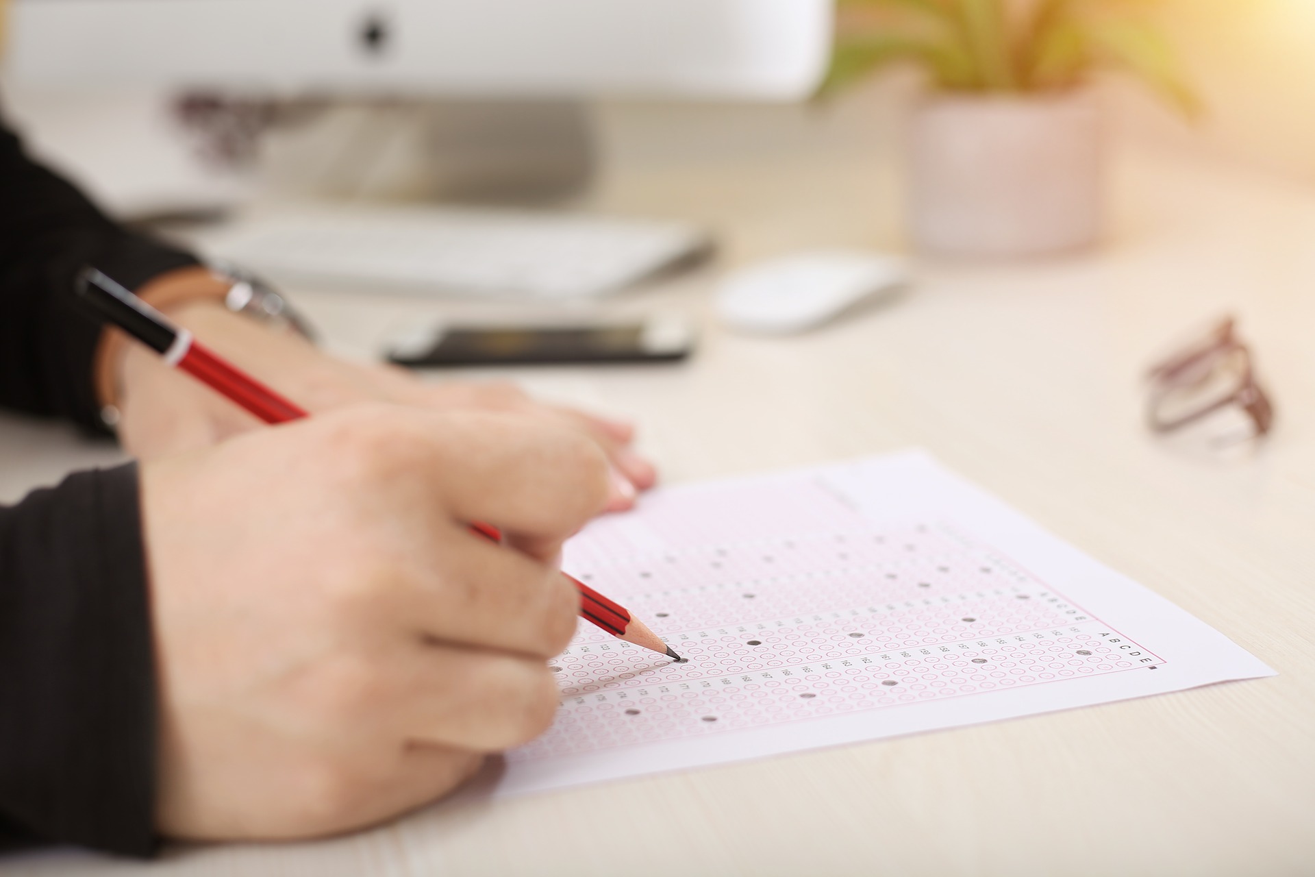 hand holding a pencil doing a written test: Exam Stress