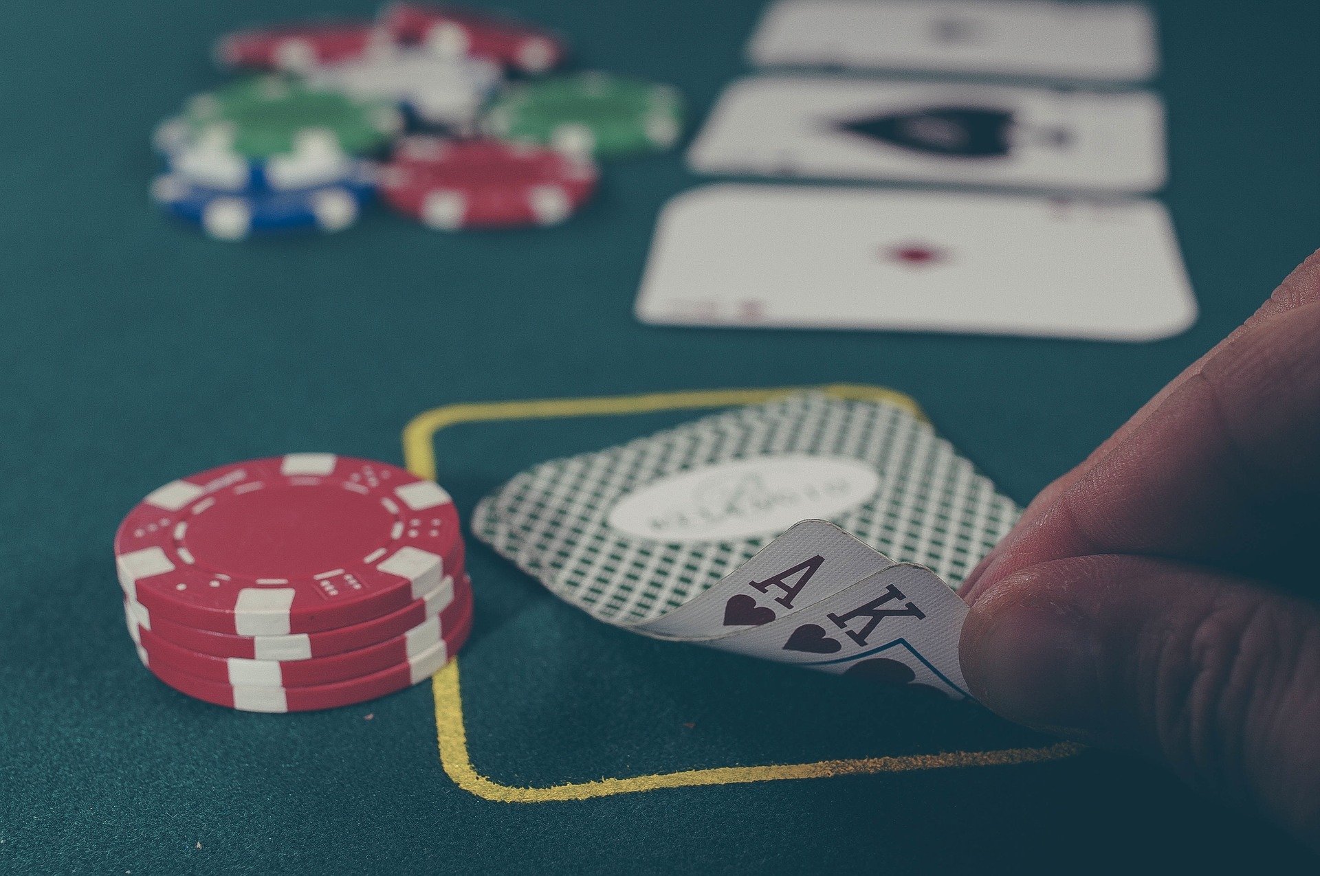 Blackjack cards Ace of spades and king of spades with poker chips on a green table. For addiction