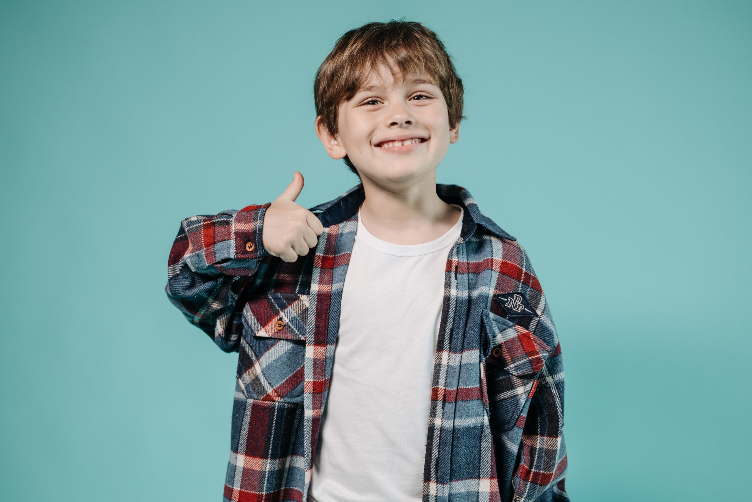 Child with thumbs up to promote good Mental Health