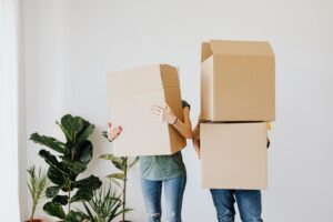 Couple moving boxes for Buy A House