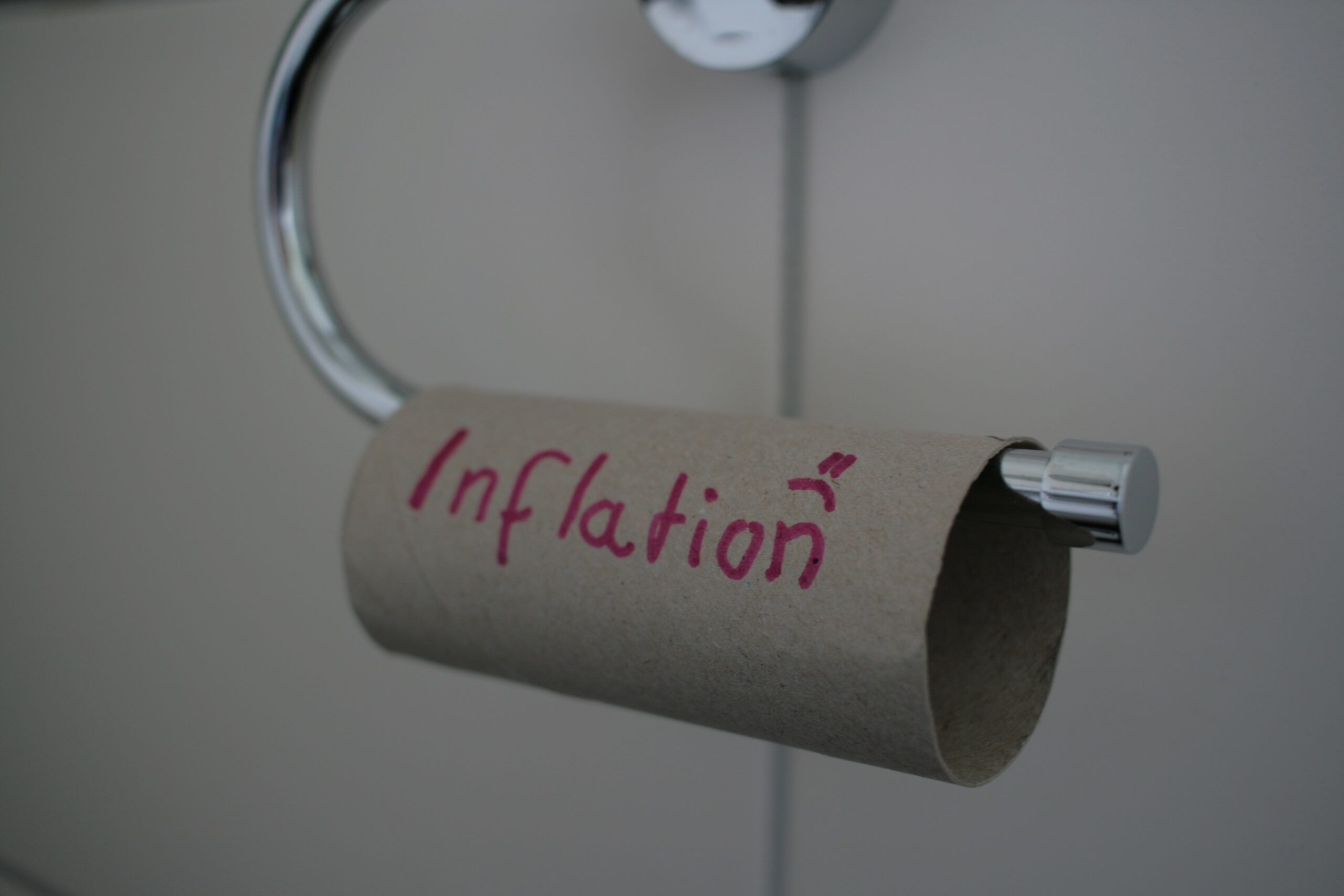 Empty toilet roll with inflation written on it with a down smiley face for British Stagflation